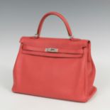 HERMÈS.Bag Model Kelly 35.Togo red pivoine leather.Slight marks of use.Made in pivoine red togo