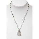 Pendant with a chain made of 18 kt white gold, with spinels and 3 mm. pearls, and with a pendant