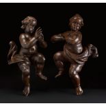 Pair of 17th century baroque putti.Carved and patinated walnut wood.In good state of preservation.