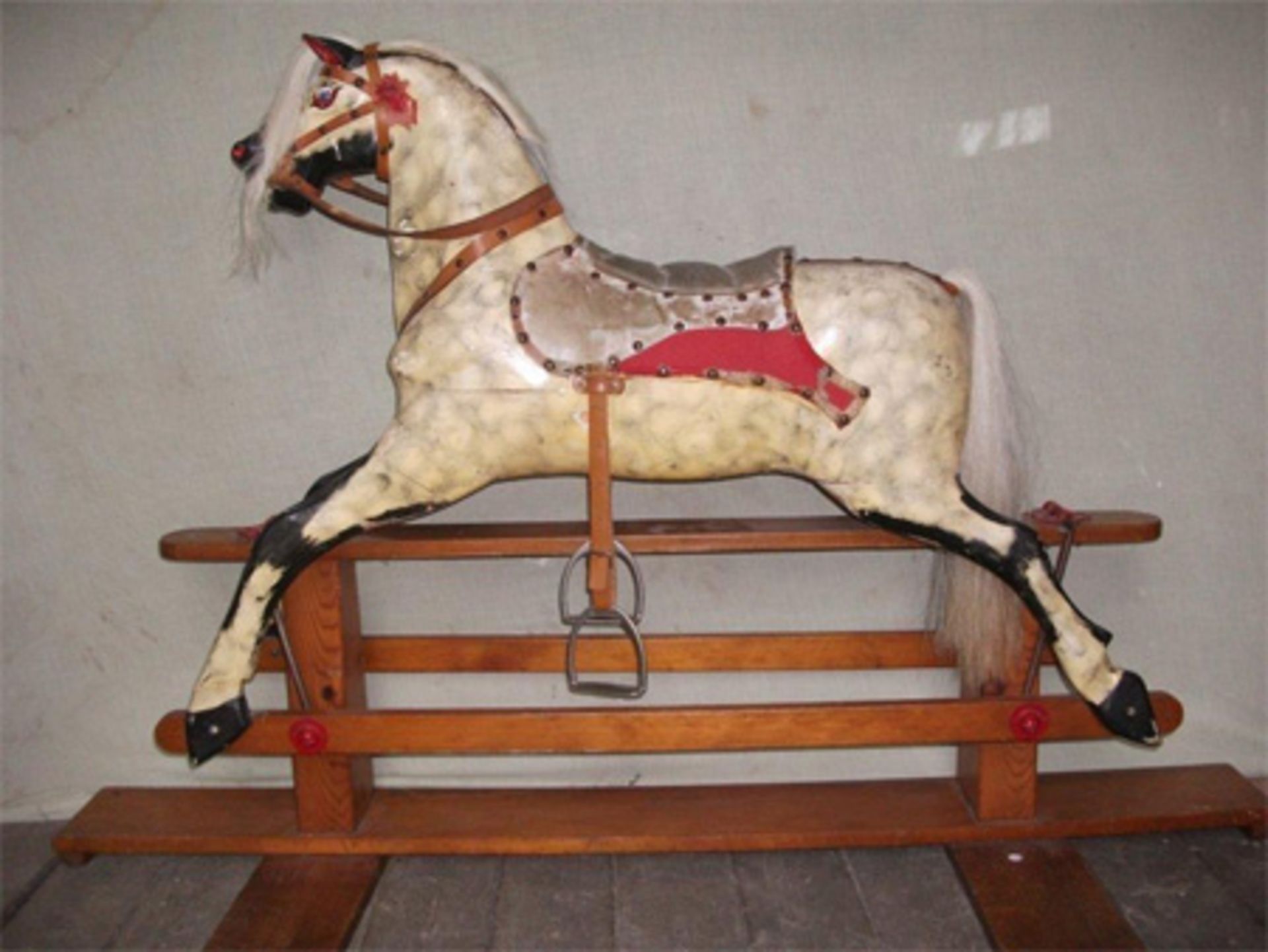 A rocking horse, a silver jug and a collection of postcards