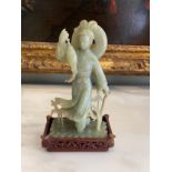 A Chinese Carved Jade Figure with a Fish on an Associated Wooden Stand