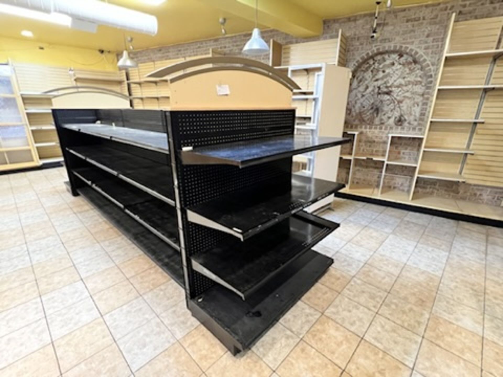 8 Section adjustable Gondola shelving system Approximately 195” Long X 50” Wide with 2 archways o