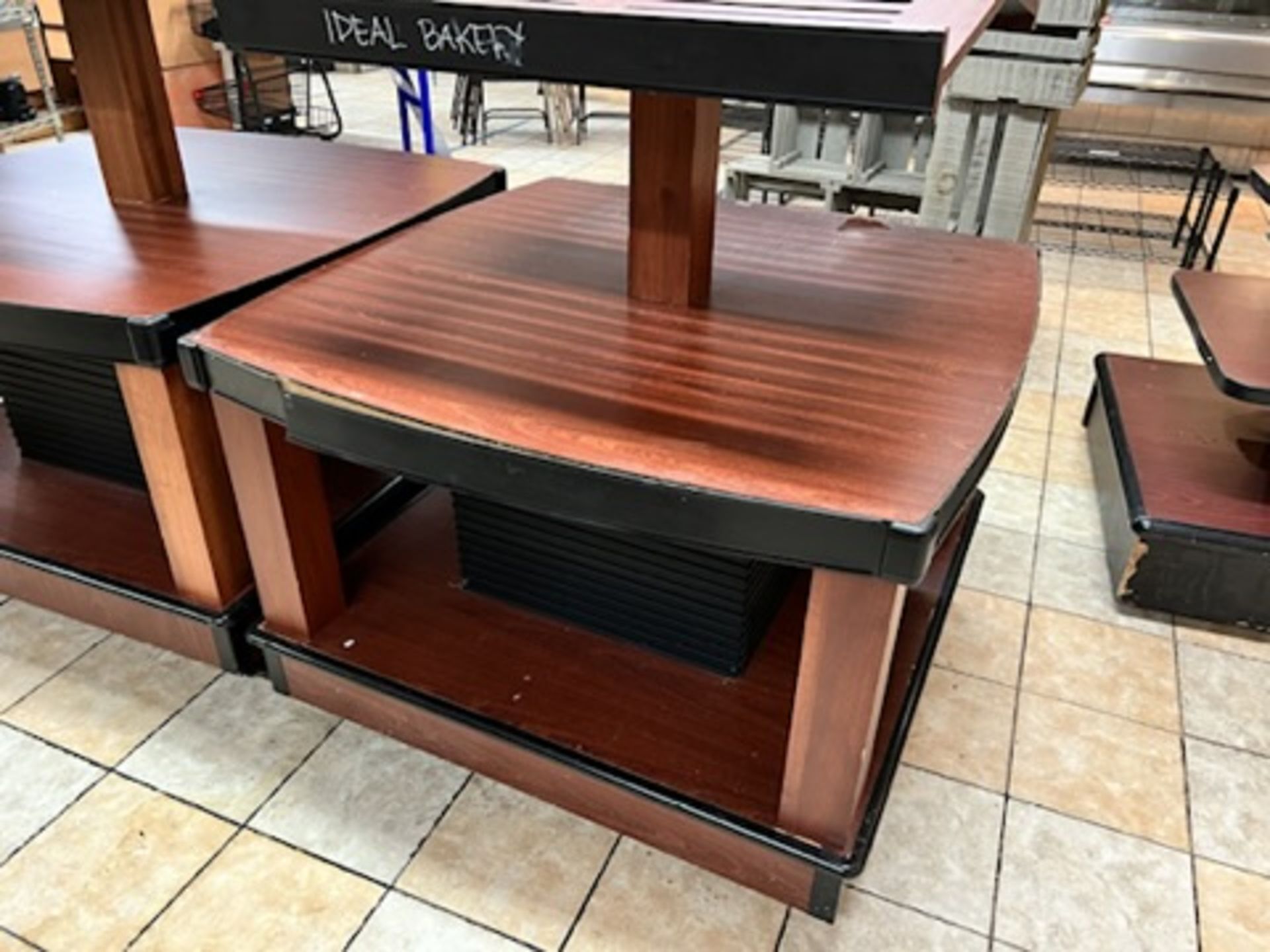 Lot of: (2) approximately 47” X 47” 2 tier wood laminate display tables w/ upper display shelving - Image 10 of 18