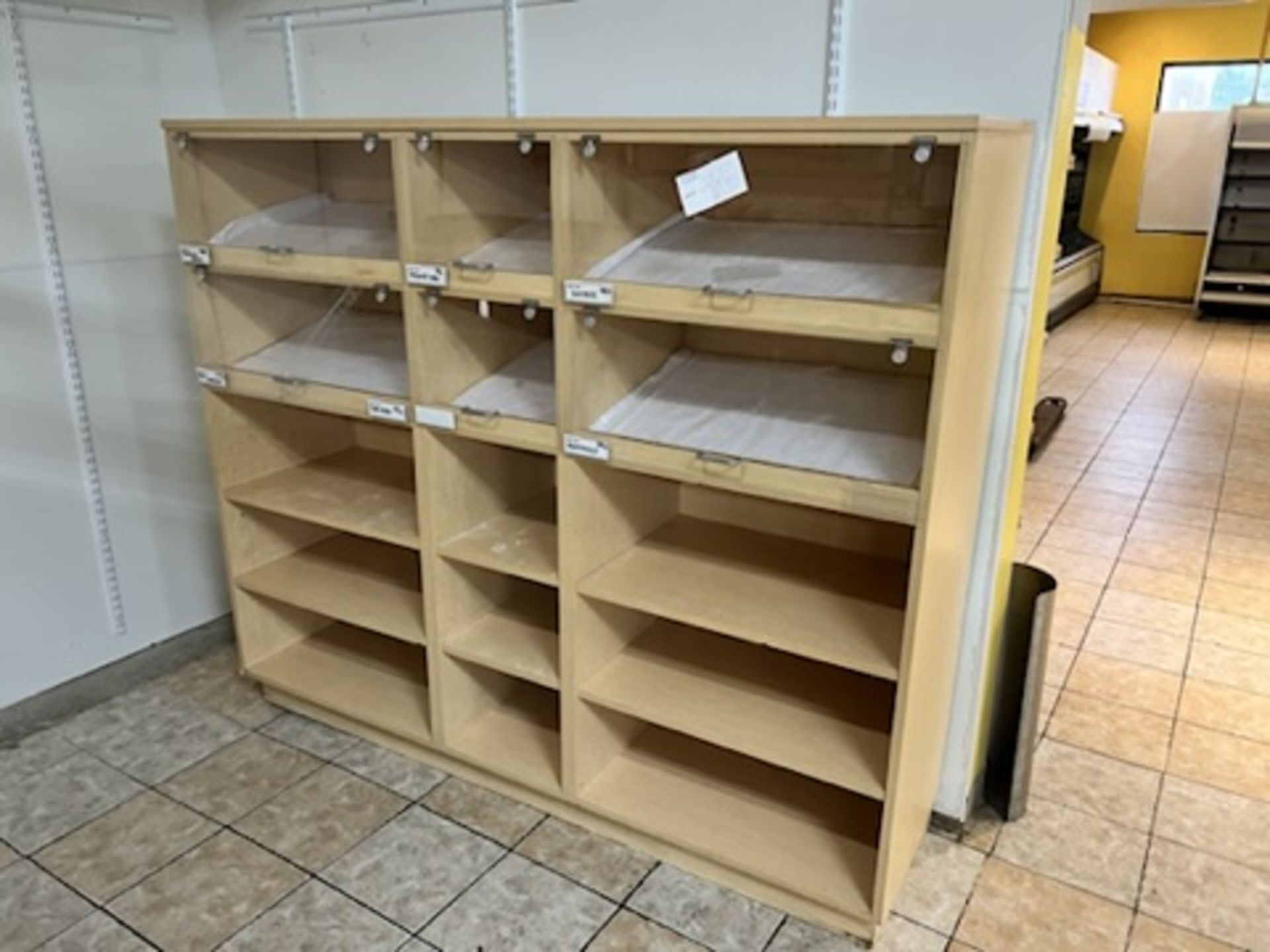 6’ Long X 62.5” X 20” wood shelving display w/ (6) plexiglass door fronts and (9) additional shelvi