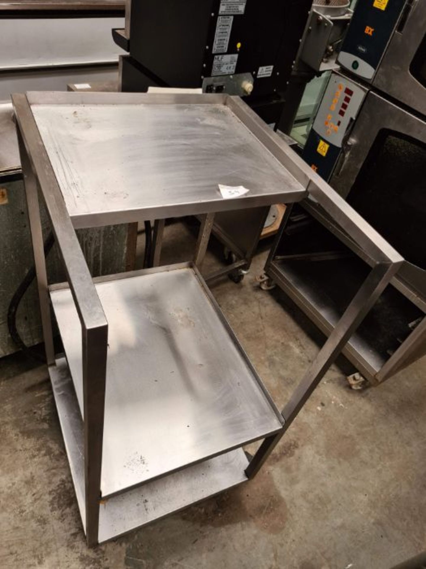 Stainless steel table, 3 shelves, on wheels.