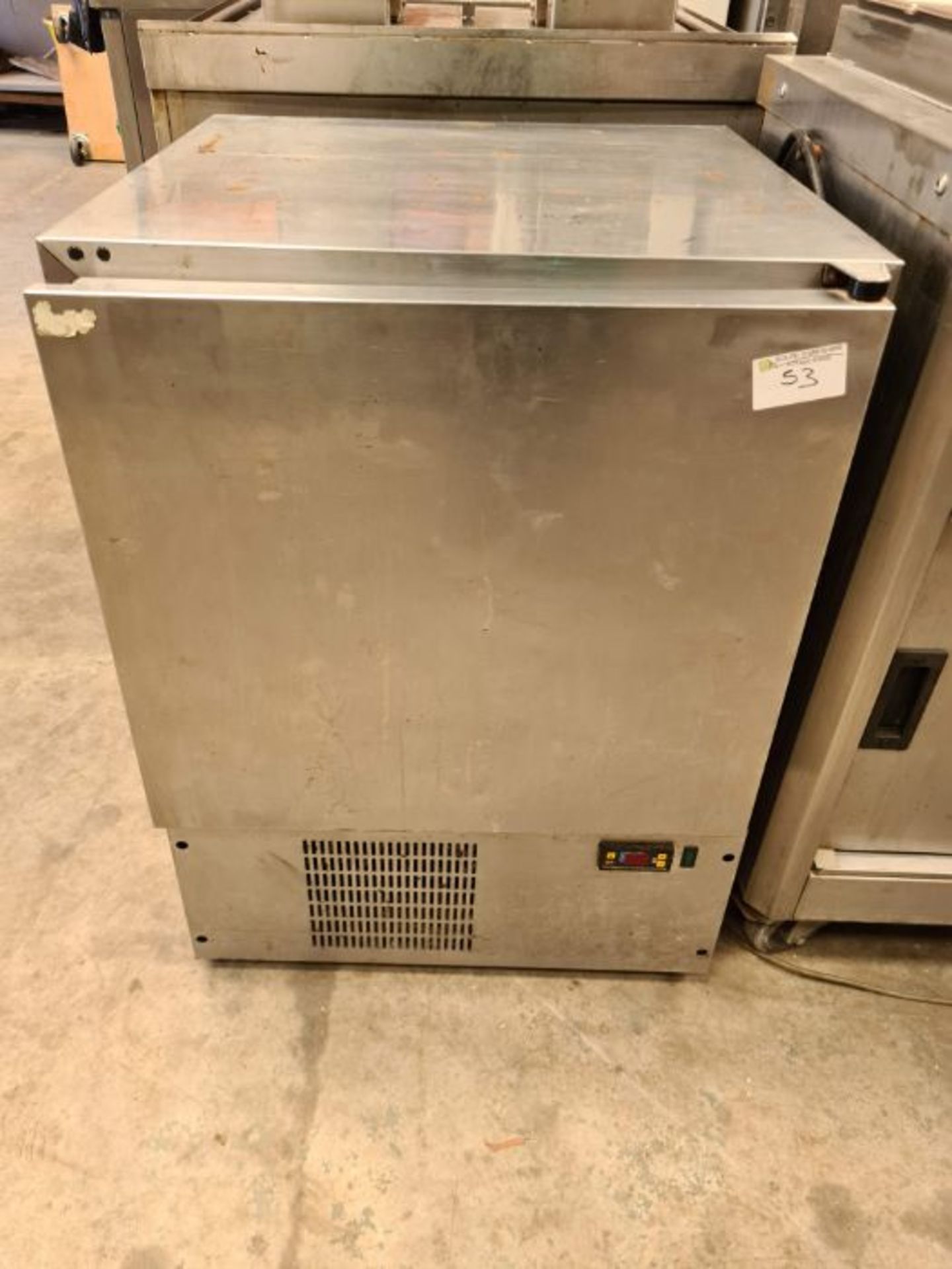Stainless steel undercounter fridge.