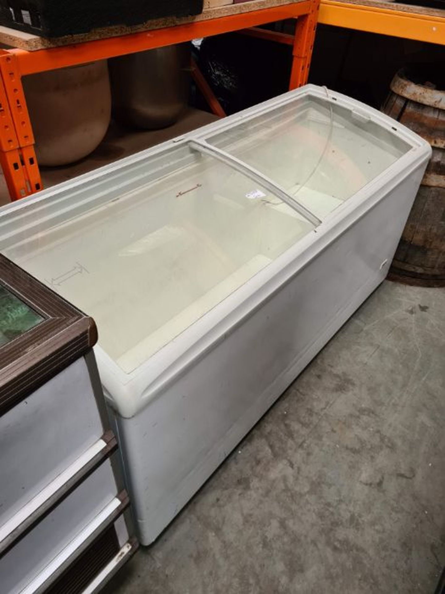 Glass top sliding lid chest freezer.