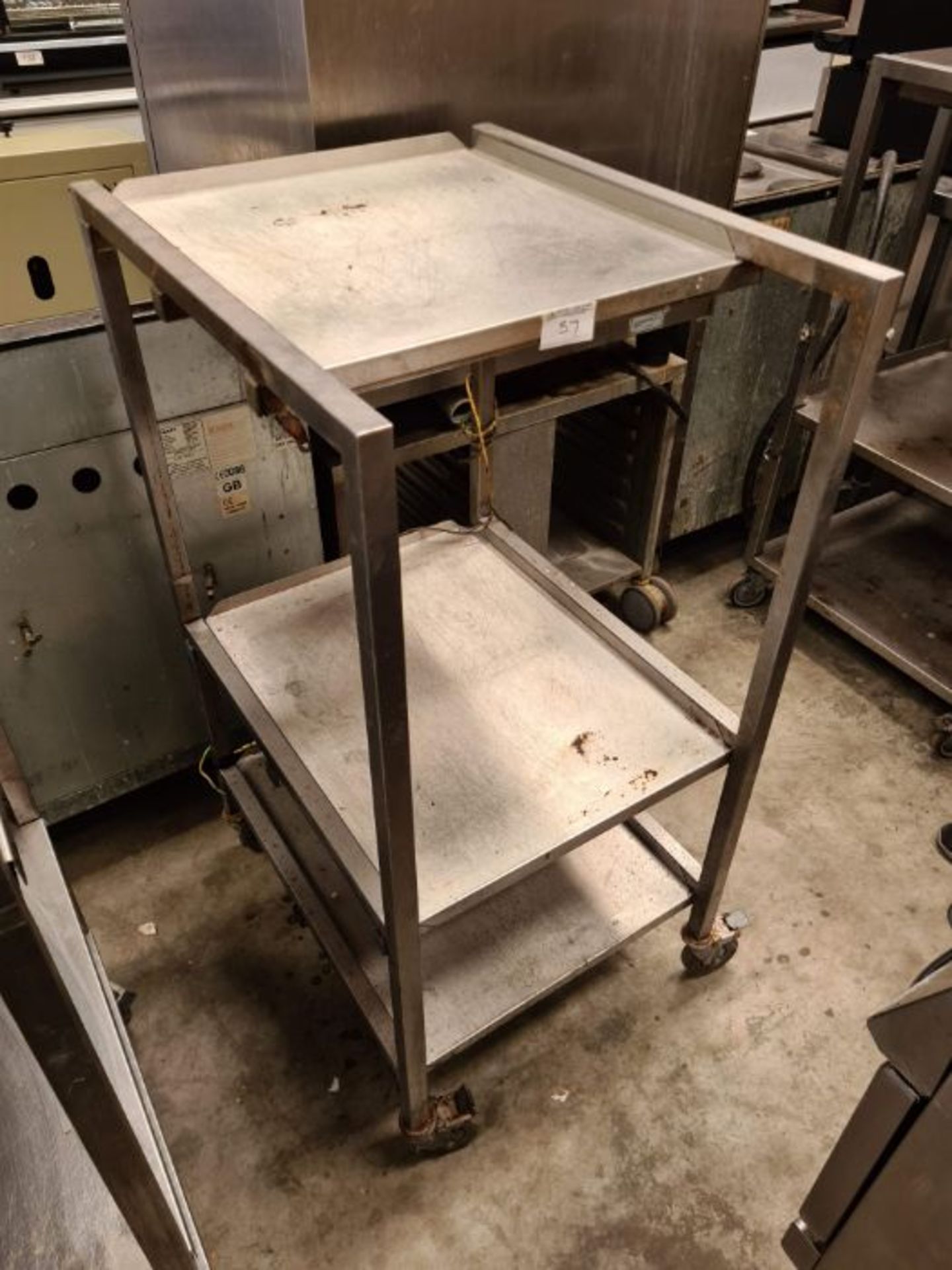 Stainless steel table, 3 shelves, on wheels.