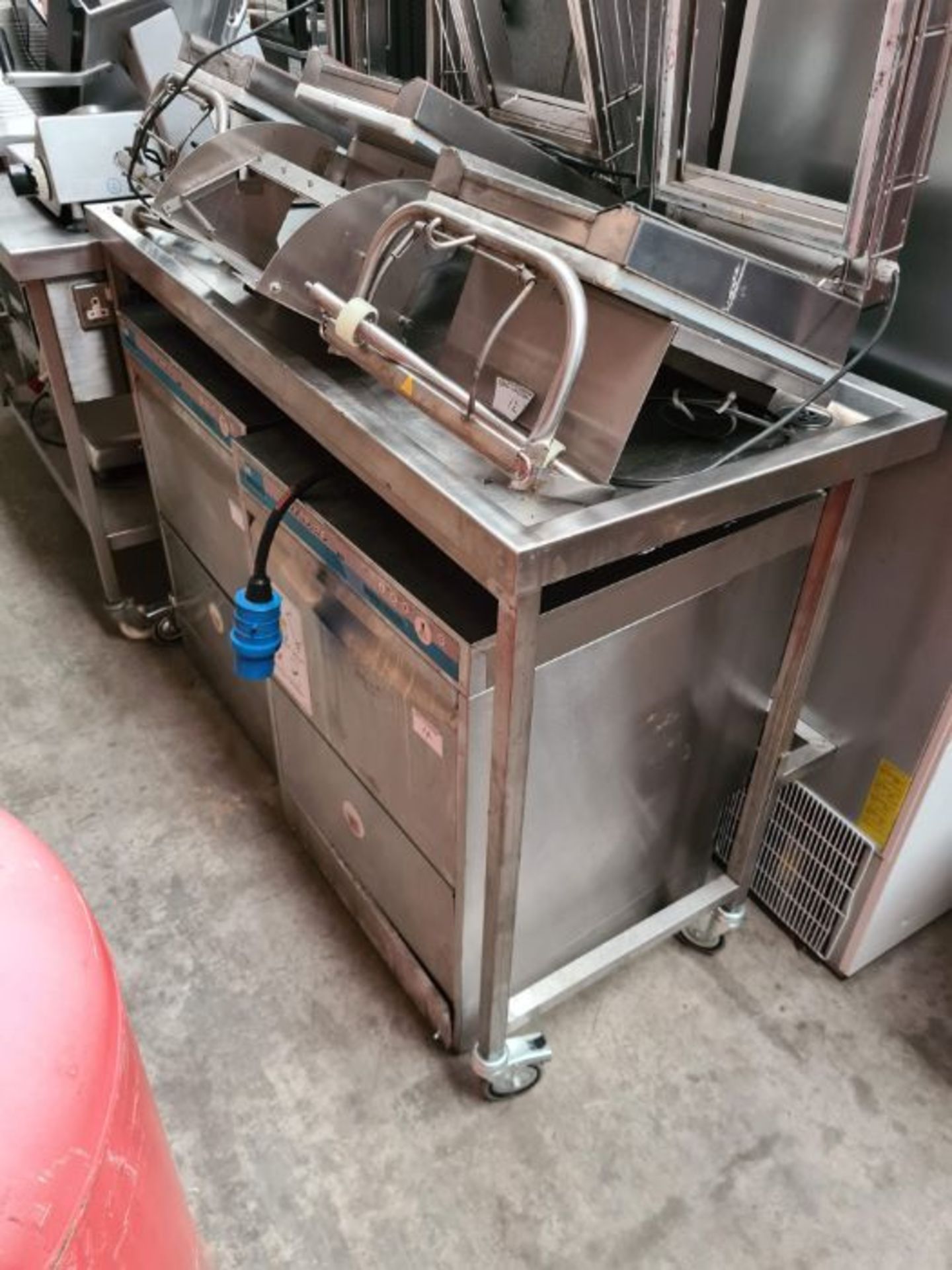 Stainless steel draining table on wheels.