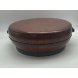 AN ANTIQUE CHINESE WOODEN RICE STORAGE CONTAINER WITH BRASS BAND AROUND AND TWIN HANDLES