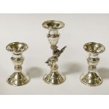 SHORT CHERUB CANDLESTICK WITH AN ACCOMPANYING PAIR OF SHORT CANDLESTICKS