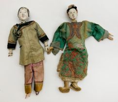 AN UNUSUAL PAIR OF ANTIQUE CHINESE DOLLS ONE WITH "LOTUS" BOUND FEET