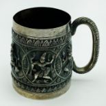 AN INDIAN SILVER (WHITE METAL) CHRISTENING MUG