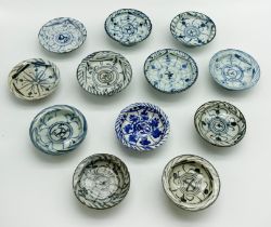 A QUANTITY OF VARIOUSLY DECORATED SOUTH EAST ASIAN STEM CUPS