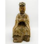 A LARGE CHINESE CARVED WOOD FIGURE OF A TUTELARY DEITY DEPICTED AS A SEATED OFFICIAL