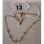 AN 18CT (MARKED 750) GOLD NECKLACE SET WITH 8 GRADUATED DIAMONDS THE LARGEST 0.75 POINTS