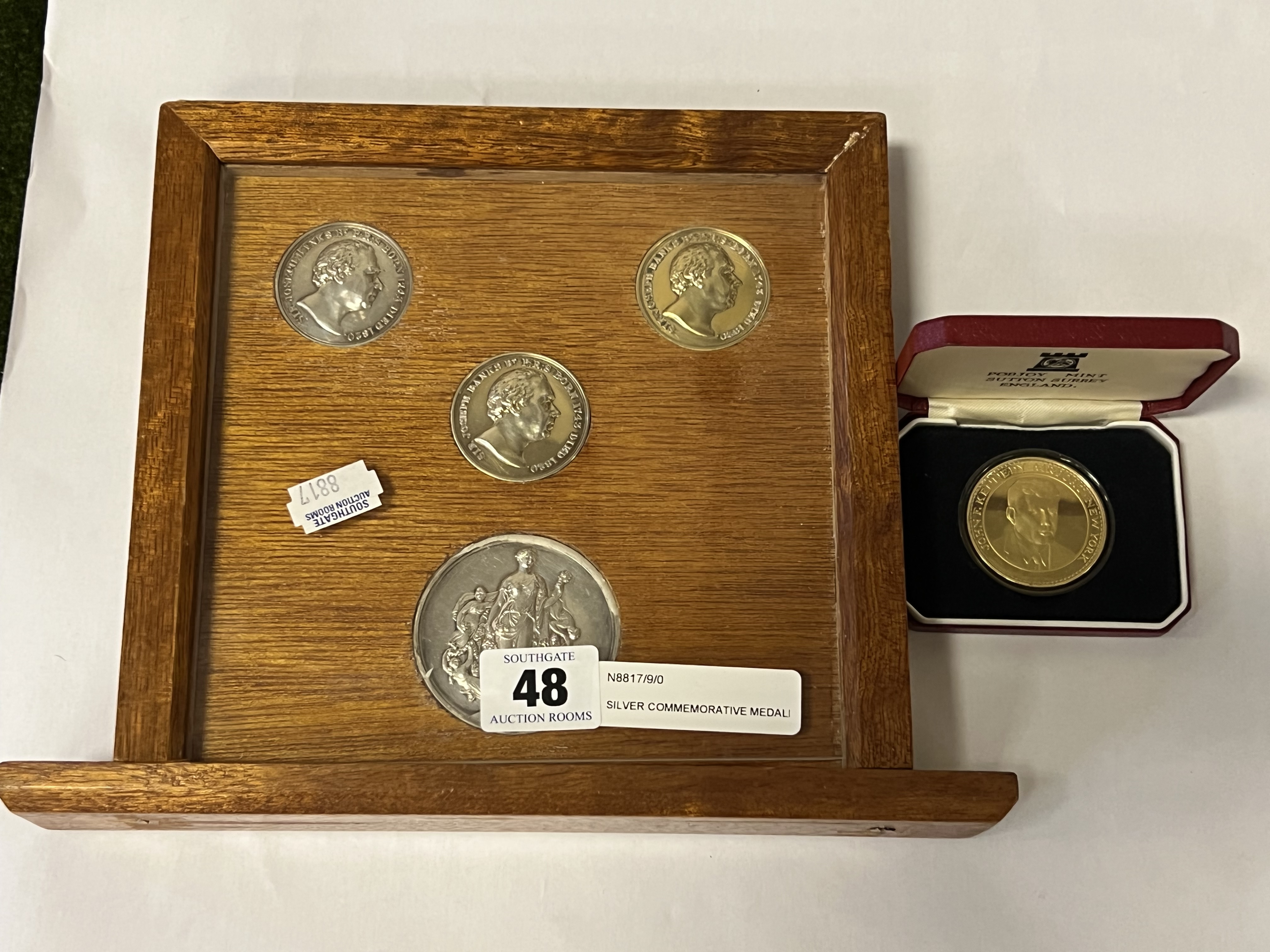 SILVER COMMEMORATIVE MEDALLIONS MOUNTED WITH ANOTHER