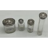 FOUR SILVER-TOPPED DRESSING SET BOTTLES