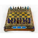 AN AUSTRO-HUNGARIAN SILVER, GILT-METAL AND ENAMEL CHESS SET AND BOARD LATE 19TH / EARLY 20TH CENTURY