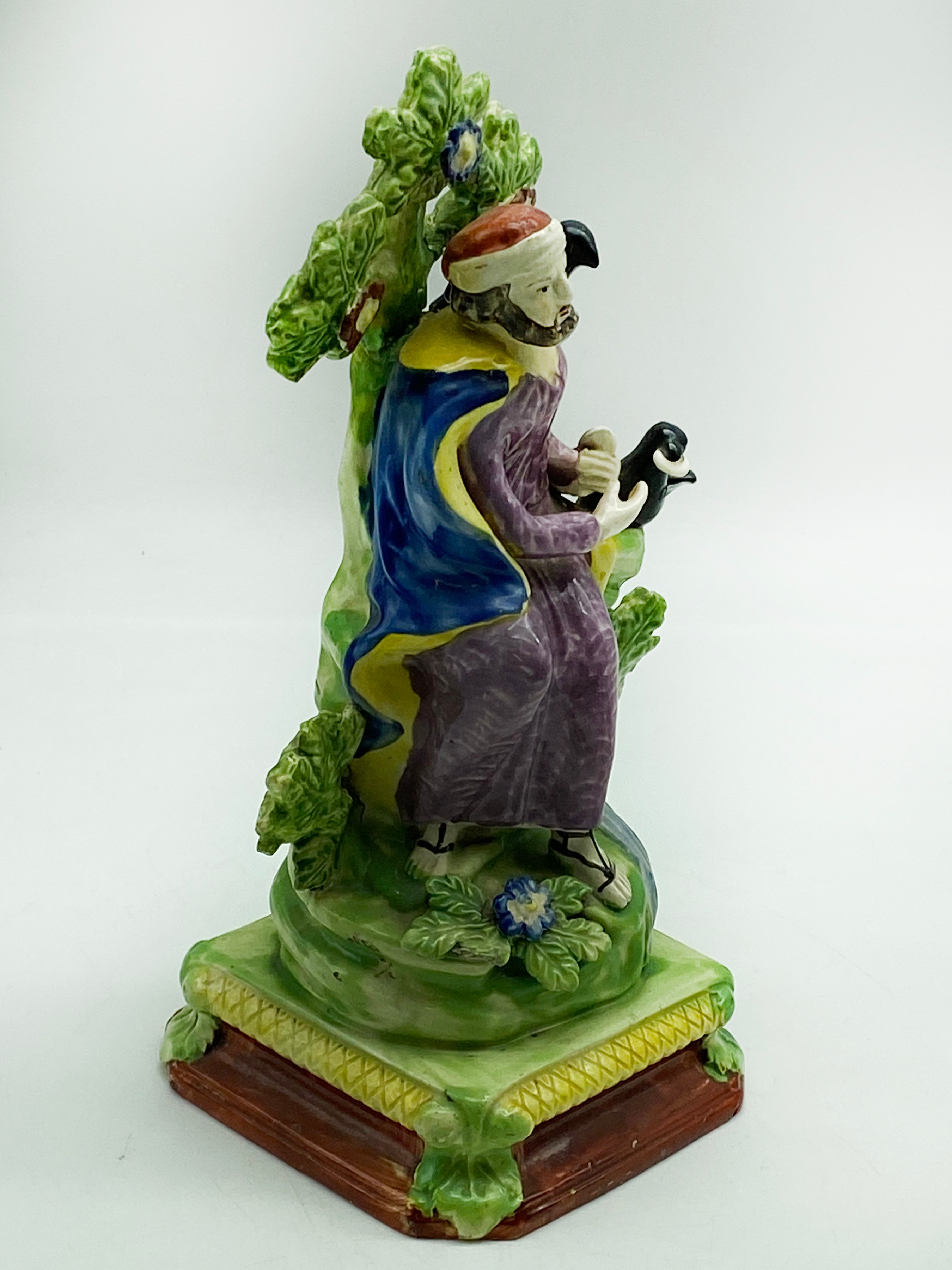 A STAFFORDSHIRE CERAMIC FIGURE DEPICTING THE PROPHET ELIJAH IN THE WILDERNESS BEING FED BY RAVENS. - Image 2 of 7