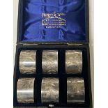 SIX SILVER NAPKIN RINGS