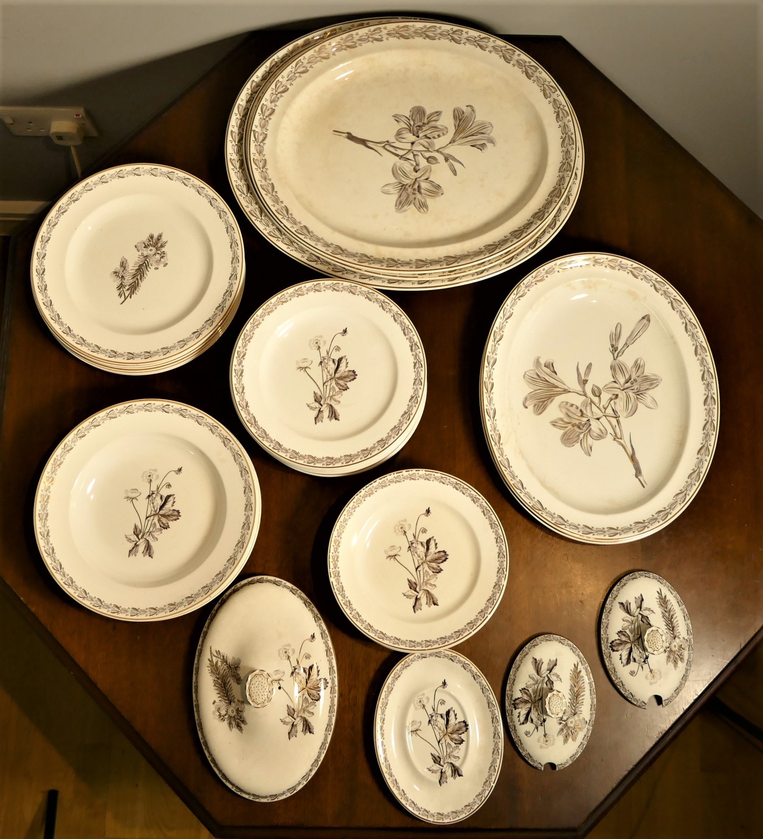 An Edwardian Wedgwood Etruria botanical part dinner service, stamped Wedgwood, Made in England, over