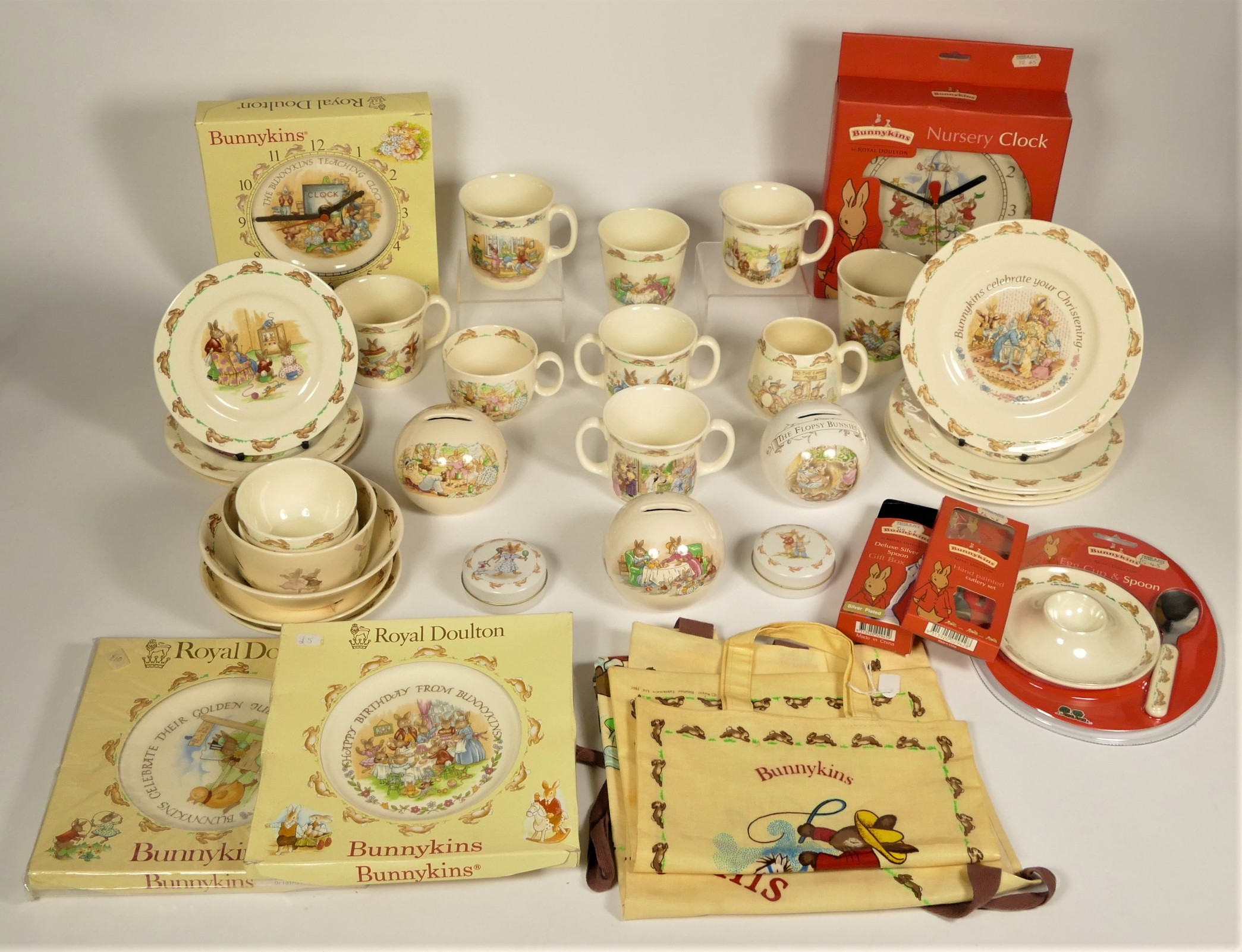 A collection of Royal Doulton Bunnykins ceramics to include, two boxed wall clocks, egg cup and