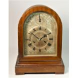 A mahogany mantle clock with gilt metal face, roman numeral dial, stamped 'Gustav Becker' on