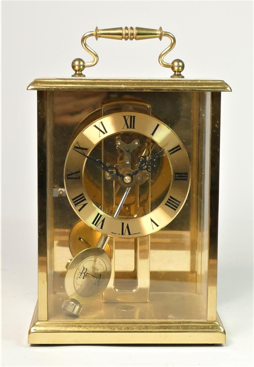 A German brass mantle clock with Roman numeral dial, with pendulum, 19cm