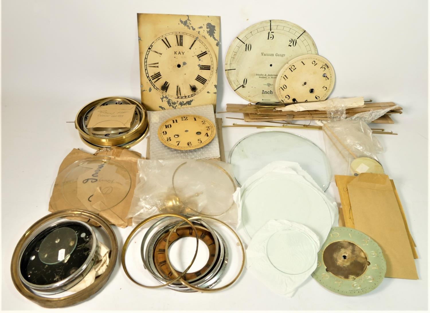 A collection of mantle clock glass and pendulums