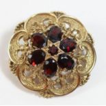 A Victorian style 9ct gold and garnet cluster brooch/pendant, set with mixed cut stones, diameter