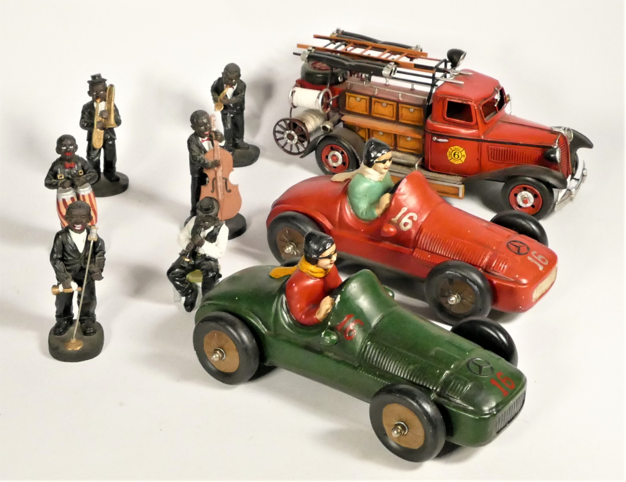 Two ceramic models of roadster race cars, together with a large tinplate model of a 1930s fire