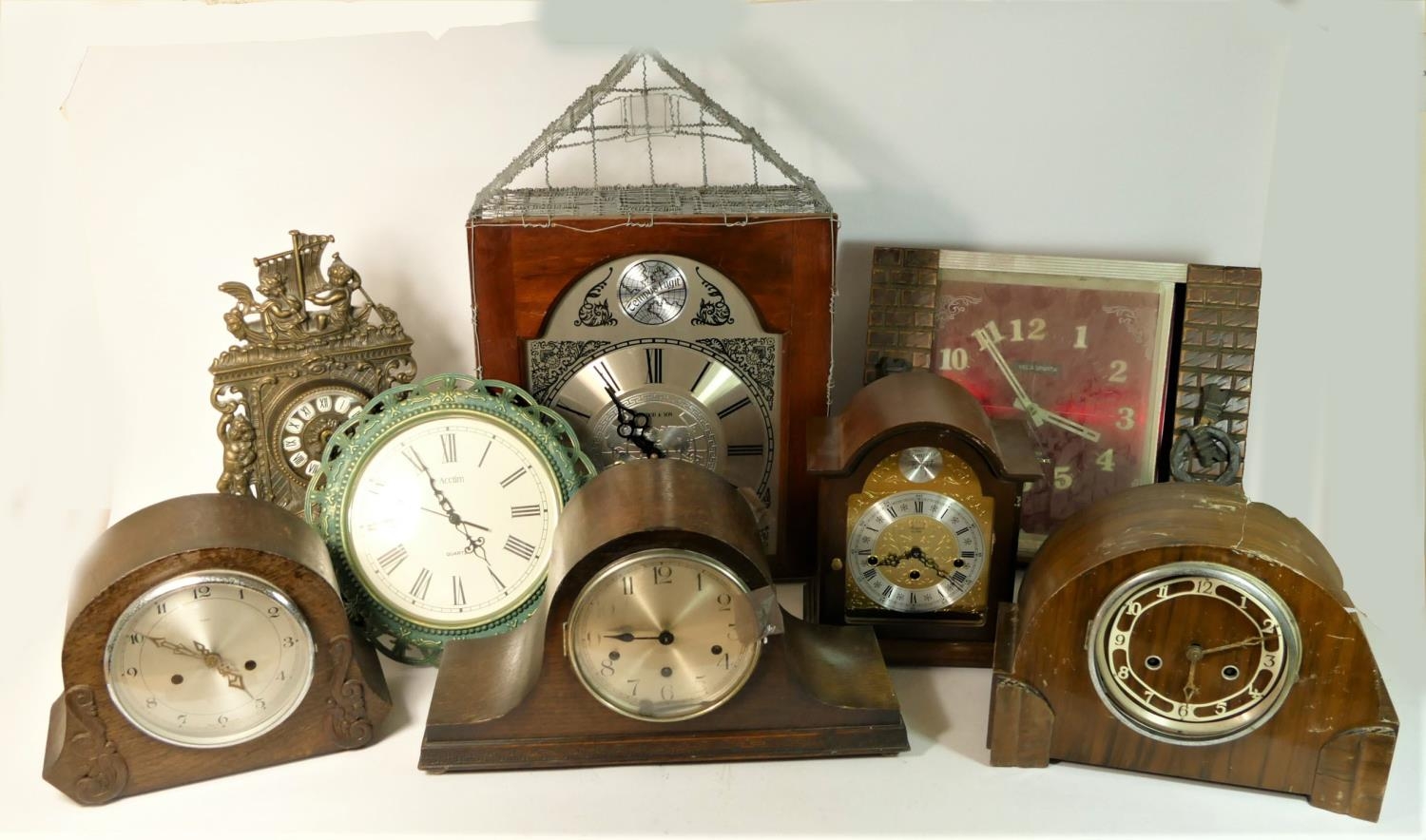 A Tempus Fugit wall hanging clock together with oak cased mantle clocks and others