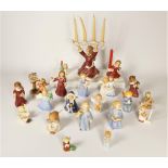 A collection of twenty Goebel angel Christmas ornaments, to include choir singers, candle holders