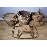 A collection of fourteen wicker baskets of various sizes, together with a bamboo & wicker child's
