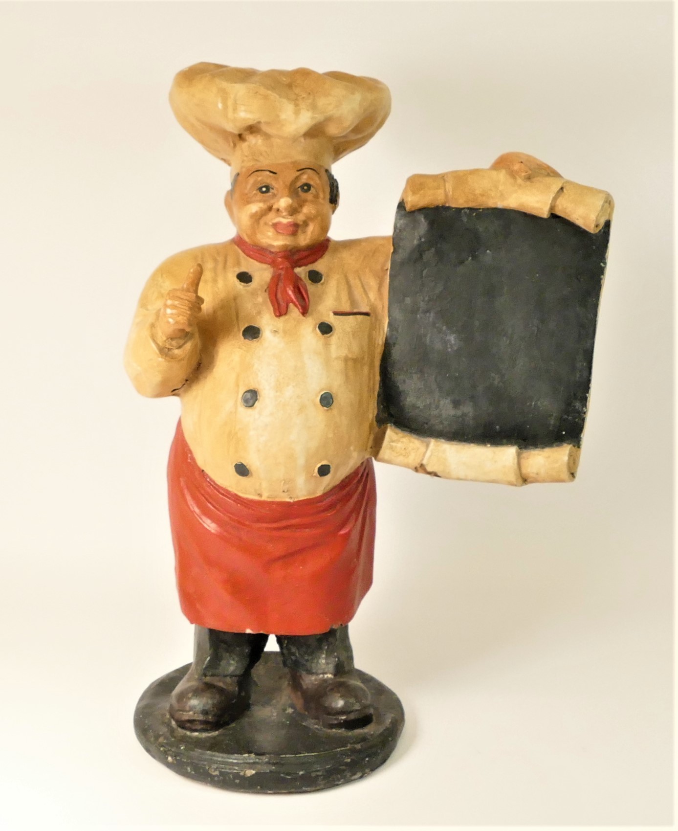 A resin statue of a baker holding a menu board, 49cm tall.