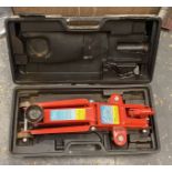 A two ton hydraulic trolley jack, cased, lacking lever arm