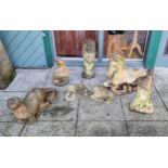 A pair of reconstituted stone lying down horse, 62 x 44cm, an otter, a small pair of lions and