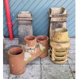 A collection of four chimney pots, 74 (damaged top), 67 and 55cm