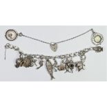 A silver charm bracelet, set with multiple charms, 62gm