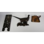 An Edwardian brush and tray crumb set, together with a carved wood wall plaque of a pheasant and