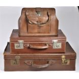 Two mid 20th Century leather suitcases, together with a brown leather passenger bag (3).