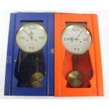 A pair of modern manual wind wall clocks having brightly painted wood cases, brass dial with roman