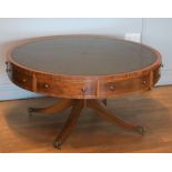 A mahogany veneered drum table, with circular embossed green skiver top with inlaid decoration,