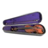 A late 19th early 20th Century violin complete with bow and hard case.