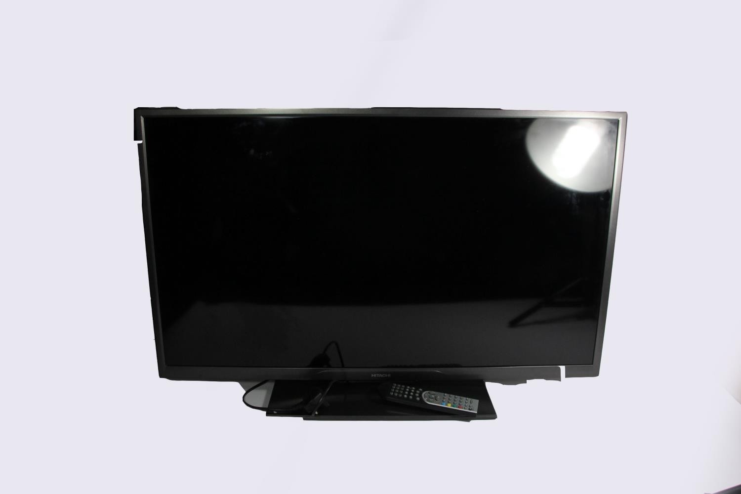 A 40" Hitachi Television, model 40HXC06UB with remote control, together with a Focalpoint Fires