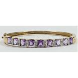 A 9ct gold amethyst and diamond hinged bangle, internal 20.5cm, 15gm