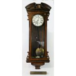 A single weight walnut cased eight day Vienna style wall clock. 105cm long.