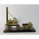 A brass Stephenson's Rocket model on wooden base, 24 x 28 cm (24 x 33 cm on base) Stephenson's