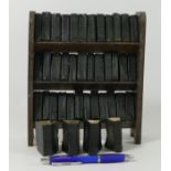 The works of William Shakespeare by Allied Newspapers Ltd in miniature on a three shelf bookcase, 40